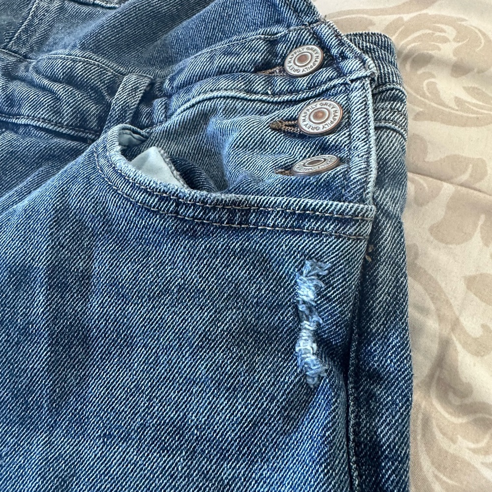 Distressed jean overalls